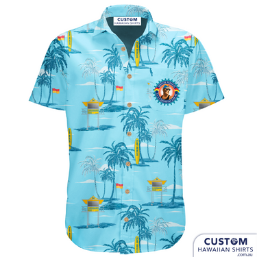 Surfers Paradise Surf Life Saving Club in Queensland wanted some new custom shirts for the Supporters Club. This is a stylish design featuring palms, Tower 34, flag and a surf board on a blue base. Open collar Top pocket with logo Embossed Coconut buttons (one spare) Aussie Designed Shirts