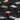 Close-up of Tamworth Classic Holden Club Shirt fabric showing detailed vintage Holden cars over grey tropical leaves on a black background.