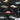 Close-up of Tamworth Classic Holden Club Shirt fabric showing detailed vintage Holden cars over grey tropical leaves on a black background.