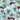 Close-up of Walker Fire Department tropical shirt fabric featuring red fire trucks, palm trees, white hibiscus flowers, and mountain accents.