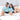 Couple lounging in matching Under The Sea mens & womens Hawaiian shirts with ocean-themed prints, ideal for cruise wear or hospitality uniforms.