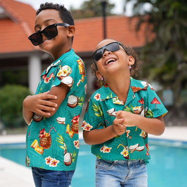 Make sure your kiddos look cool and trendy in our Coco Crush Hawaiian Shirt! With its Cotton/Rayon blend print of tropical coconuts and pineapples, they'll be ready to take on summer with style and comfort.</p> <p data-mce-fragment="1">The perfect ensemble for a day of casual cruising with the whole family! This Unisex design so everyone has a matching look and suits boys or girls.
