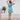 Back view of women's Christmas Pool Party dress with ruffle hem and tropical Santa print, ideal for warm-weather holiday events.