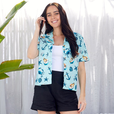 Under The Sea Womens Hawaiian Shirt in light blue with marine motifs like crabs, shells, and anchors. Ideal tropical cruise and resort wear.