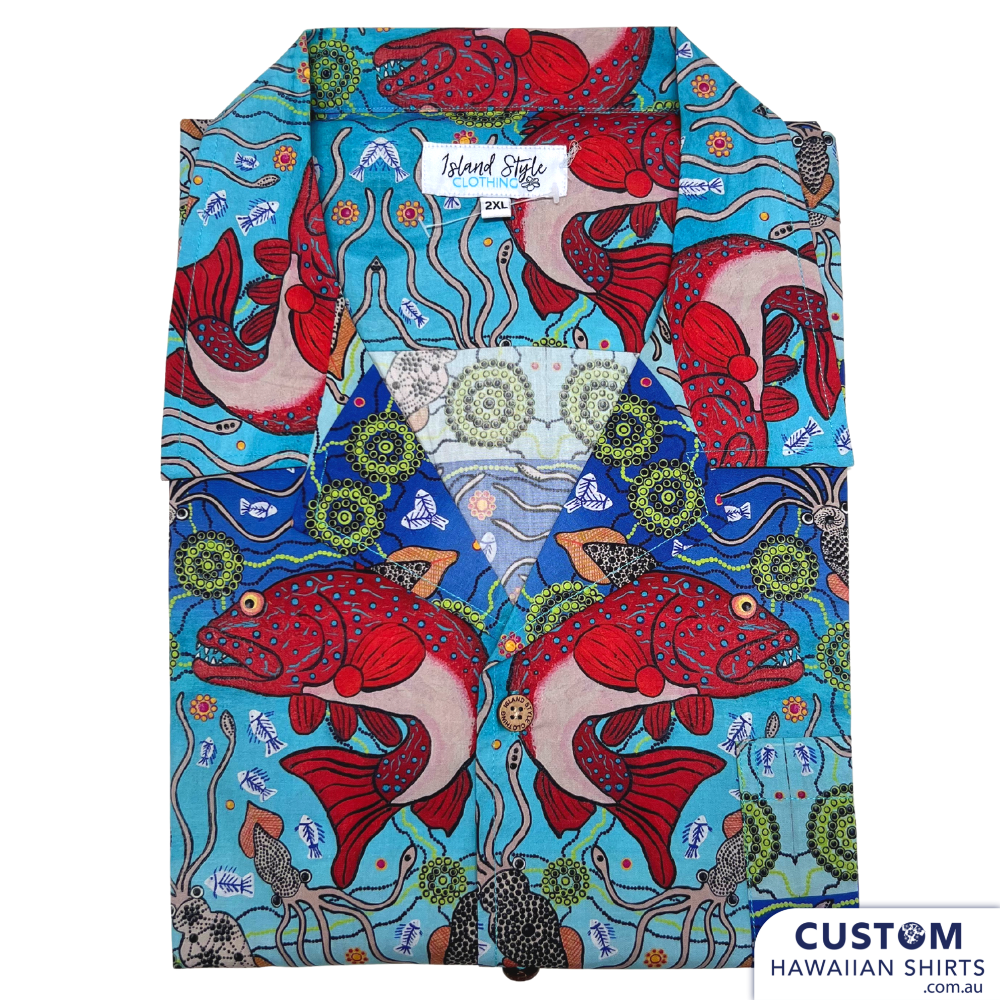 Customised Shirts made for Kuku Bulkaway Indigenous Art Gallery, Cooktown, FNQ. They paint stories they were taught as children about the local bush, food and animals. They supplied photos of their hand-painted art (original paintings you can view in our photo gallery). From there our clever design team created a seamless pattern and we turned them into wearable art on shirts and shorts. Deadly style! Main feature is Coral Trout 100% Cotton Hawaiian Shirts and Shorts