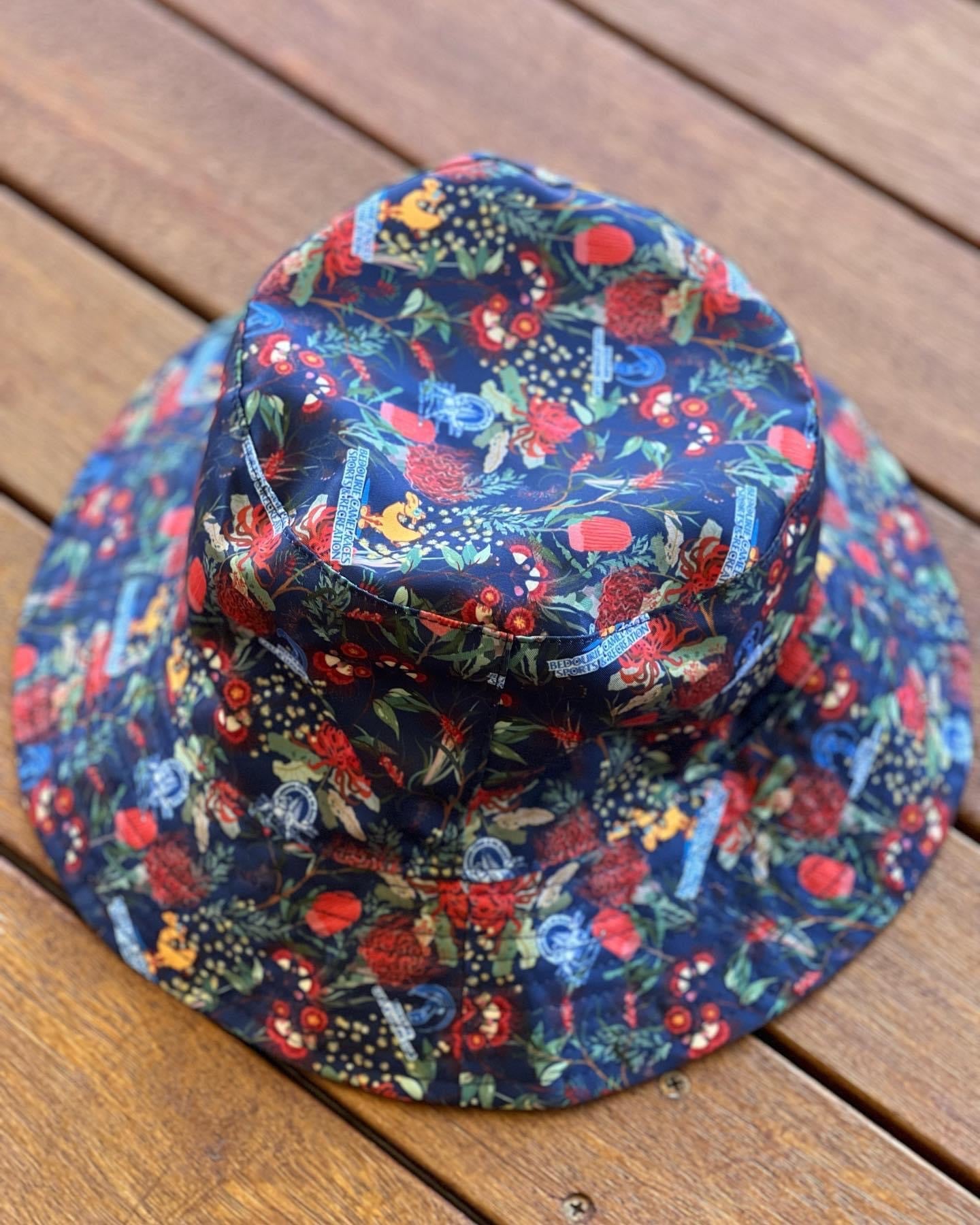 Bedourie Golf & Leisure Club geared up with some wicked personalised merch for their annual 'Camel and Pig Races' out west QLD. We designed and made for them reversible Custom Bucket Hats to match Hawaiian Shirts. Ridgey Didge best event festival merch. Designed with Australian botanicals.