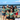a group of women standing on top of a sandy beach