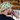 a man wearing a custom bucket hat drinking a can of beer