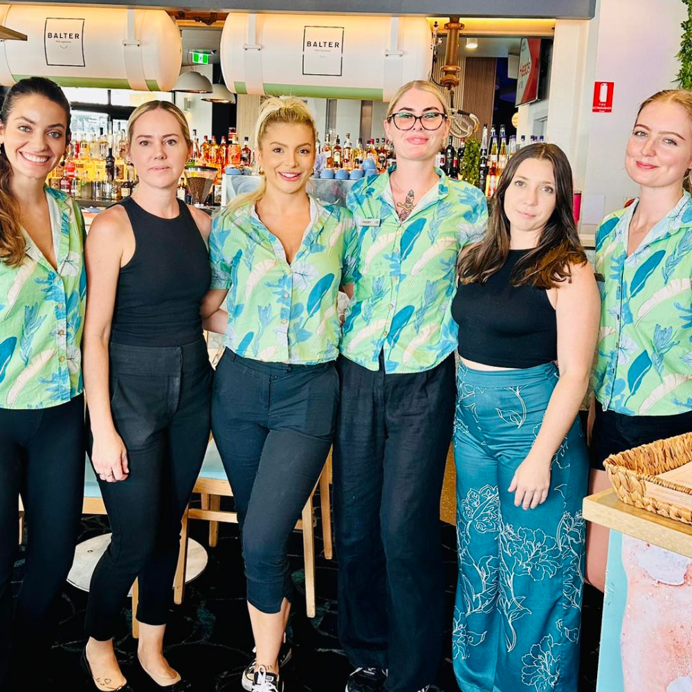 Bar and Hotel staff shirts custom-designed hospitality uniforms for Burleigh Heads Hotel. This is their second order of personalised Hospitality shirts. This new design has large tropical leaves with a green base and once again fit the vibes of this iconic GC Hotel