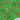 Patterned fabric with horses, palm trees, presents, and Christmas elements on a green background.