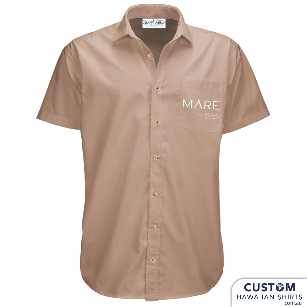 Bar and Hotel staff shirts custom-designed hospitality uniforms for La Luna Beach Club, GC. These personalised Hawaiian shirts were plain with their logo on the pocket.  Custom Hospitality Shirts 100% Cotton Open collar Logo on pocket Blue & Tan version Coconut buttons Free design by our in-house designers on Sunny Coast