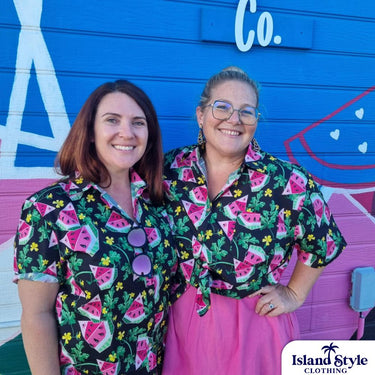 Two women wearing Red Hill Creative - Melon Malarkey custom shirts with watermelon and yellow flower print, showcasing fun festival apparel.