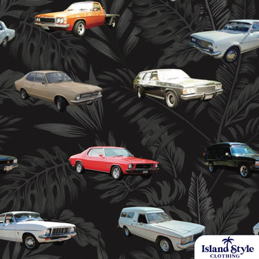 Close-up of Tamworth Classic Holden Club Shirt fabric showing detailed vintage Holden cars over grey tropical leaves on a black background.