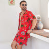 a man in a red hawaiian Christmas shirt standing next to a shelf