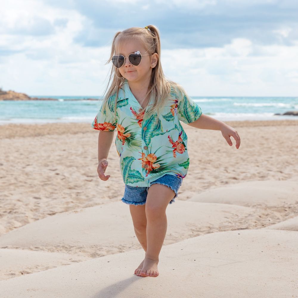 Treat your little one to some summertime fun with the Green Paradise - Kids Unisex Hawaiian Shirt. Made with 100% cotton and totally tropical print, it’s the perfect way to send them off for cruises and casual adventures.  Plus, you can even coordinate the whole fam with matching items! Aloha, summertime! View the Paradise Collection. 