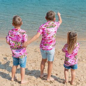 Put a smile on your kids' faces and let them “flamingle” with this Pink Flamingo Kids Unisex Hawaiian Shirt! Featuring eye-catching pink flamingos on a pink base, this soft rayon shirt is perfect for summer fun and cruisewear.  Get the matching items for the whole family and create a coordinated look! View the Pink Flamingo Collection. 