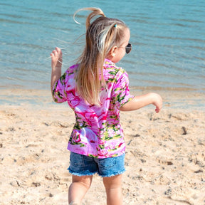 Put a smile on your kids' faces and let them “flamingle” with this Pink Flamingo Kids Unisex Hawaiian Shirt! Featuring eye-catching pink flamingos on a pink base, this soft rayon shirt is perfect for summer fun and cruisewear.  Get the matching items for the whole family and create a coordinated look! View the Pink Flamingo Collection. 