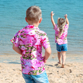 Put a smile on your kids' faces and let them “flamingle” with this Pink Flamingo Kids Unisex Hawaiian Shirt! Featuring eye-catching pink flamingos on a pink base, this soft rayon shirt is perfect for summer fun and cruisewear.  Get the matching items for the whole family and create a coordinated look! View the Pink Flamingo Collection. 