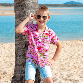 Put a smile on your kids' faces and let them “flamingle” with this Pink Flamingo Kids Unisex Hawaiian Shirt! Featuring eye-catching pink flamingos on a pink base, this soft rayon shirt is perfect for summer fun and cruisewear.  Get the matching items for the whole family and create a coordinated look! View the Pink Flamingo Collection. 