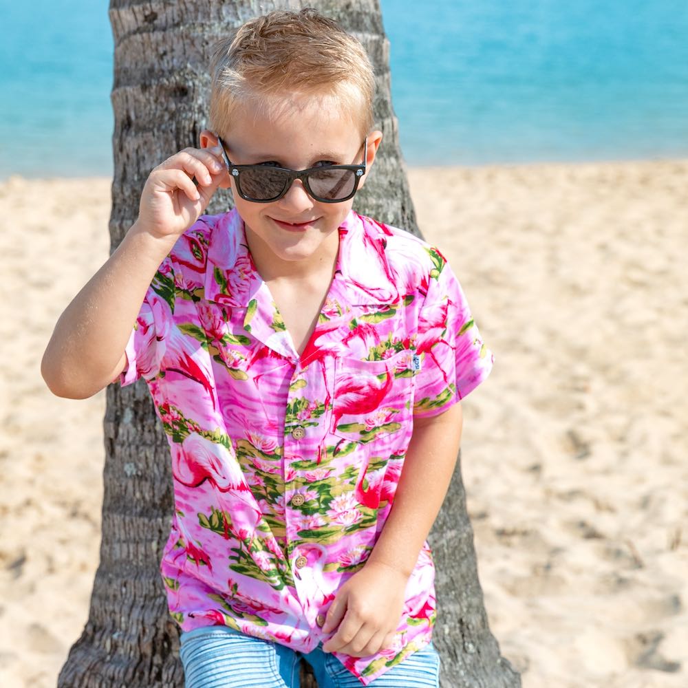 Put a smile on your kids' faces and let them “flamingle” with this Pink Flamingo Kids Unisex Hawaiian Shirt! Featuring eye-catching pink flamingos on a pink base, this soft rayon shirt is perfect for summer fun and cruisewear.  Get the matching items for the whole family and create a coordinated look! View the Pink Flamingo Collection. 