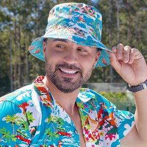 Stand out from the crowd in this Christmas print Bucket Hat! It's made for the Aussie summer and get for keeping off the sun on Christmas Day.  One side is our Christmas Pool Party and the other side Blue Surfing Santa.  It also perfectly pairs with the matching Xmas shirts and swim shorts.  View the Christmas Collection.   ONE SIZE - 60cm Circumference