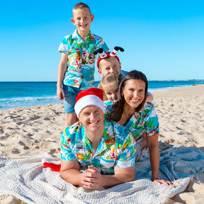 Surf's up, Santa! Get ready to catch a wave wearing this fun and festive Blue Surfing Santa Shirt! It's made of 100% cotton, making it perfect for the Australian summer.  And with Santa, reindeer, and more, it's the perfect way to get into the Christmas spirit! Check out the matching bucket hats and shirts for kids too! Ho-ho-ho!   