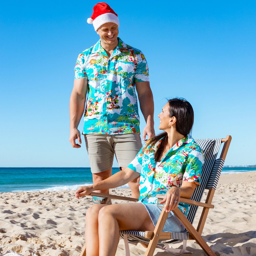 Surf's up, Santa! Get ready to catch a wave wearing this fun and festive Blue Surfing Santa Shirt! It's made of 100% cotton, making it perfect for the Australian summer.  And with Santa, reindeer, and more, it's the perfect way to get into the Christmas spirit! Check out the matching bucket hats and shirts for kids too! Ho-ho-ho!   