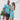 Christmas Pool Party Couple Set featuring matching men's shirt and women's dress with Santa, cocktails, and palm trees on aqua blue fabric.
