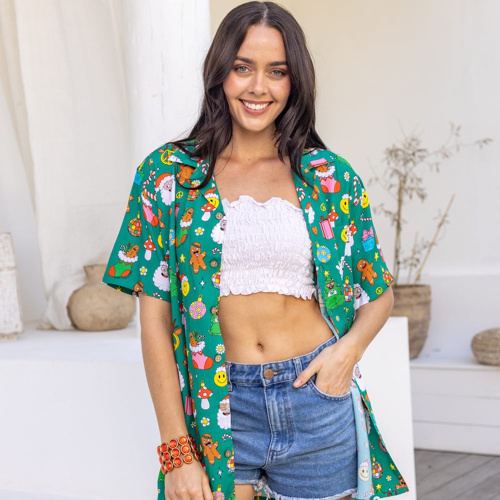 This Holidaze shirt is sure to turn heads and spark joy! You'll be the envy of the party in this 'groovy' 100% soft rayon shirt, boasting a vibrant green base and retro-inspired Christmas elements like Santa, gingerbread and of course lots of smiley faces! Deck the halls and your wardrobe!