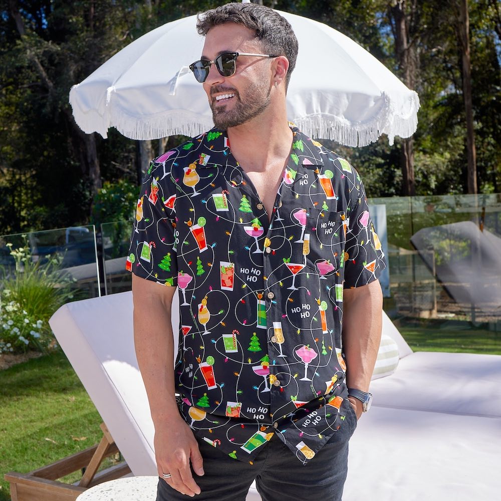 Get ready to party with the Christmas Spirits Men's Festive Shirt! Crafted from 100% rayon, it's the perfect way to show off your Yuletide jollity. With a vibrant Christmas-themed print of cocktails and twinkle lights, this shirt will have your holiday cheer up in lights!