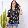 This super-soft rayon holiday-themed shirt will have you feeling merry and bright in no time! Featuring a colourful array of festive cocktails and twinkly Christmas lights over a sleek black base, it's the perfect addition to your holiday wardrobe! 'Cheers' to a fashionable holiday season! 😉