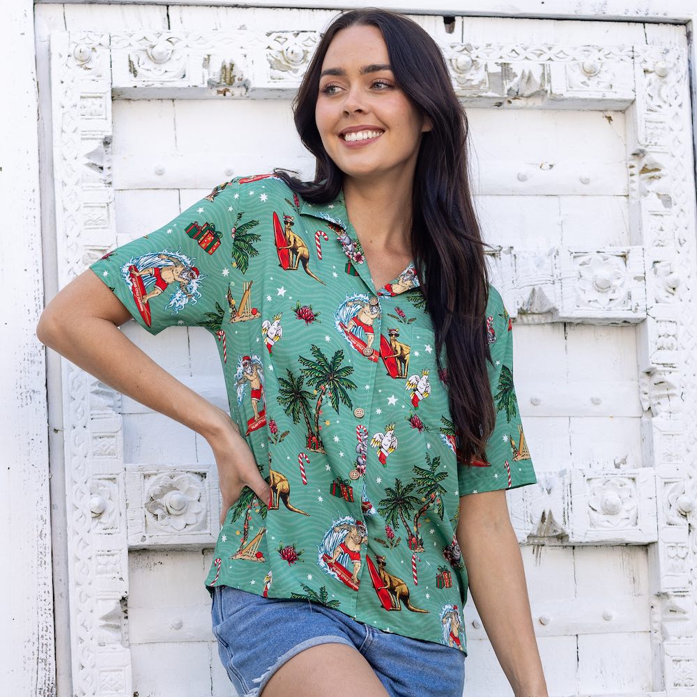 You'll be dashing through the beach in style with this Aussie Christmas Green Women's Festive Shirt! Show off your love for the Land Down Under with this 100% rayon shirt. This shirt features the ultimate Aussie Christmas look - with Surfing Santa, Kangaroos, Koala Bears, Cockatoos and Australian Flora in tow! Strike a festive pose! Make a list.... check it twice... then place your order with Island Style Clothing. 🤙 