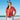 a woman standing on a beach wearing a red shirt and reindeer antlers on her