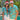 a man and a woman standing next to a pool in Christmas shirts