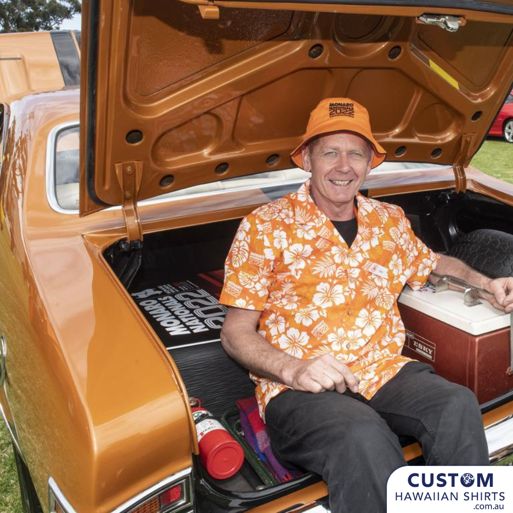 Custom Hawaiian Shirts for Monaro Nationals 2022. An orange base with classic hawaiian flowers, hibiscus, palms leaves and their logo. Personalised for this event.