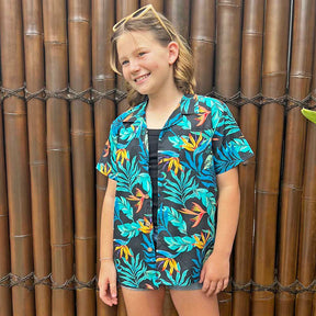 Make sure your kiddos look cool and trendy in our Jungle Fever Hawaiian Shirt! With its 100% cotton print of tropical lush leaves, they'll be ready to take on summer with style and comfort.  The perfect ensemble for a day of casual cruisin' with the whole family! Unisex design so everyone can have a matching look! 