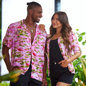 This classic men's Hawaiian shirt features vibrant pink flamingos printed on 100% rayon fabric. Complete with coconut buttons, it's perfect for a stylish yet comfortable island-style look. Steal the spotlight everywhere you go.  Go all out matching with the whole family! Shop the Pink Flamingo Collection. 