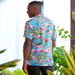 Let your aloha spirit soar with this Turquoise Flamingo Mens’ Hawaiian Shirt: a perfect combination of pink flamingo and tropical vibes for your next beach party or festival! Slip into 100% soft rayon and show your wild side! (And do it in style!)  Double up with the matching Ladies Hawaiian Shirt or go all out matching with the whole family! View the Turquoise Flamingo Collection. 