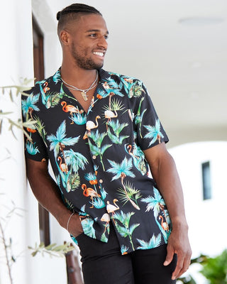 The perfect party shirt! It's cool and comfortable with a stand out flamingo and palm trees print on a black base. Double up with the matching shorts.  Take your look to the next level by adding matching Shorts, Kaftans, and Crop Shirts. View the Flamingo Nights Collection. 