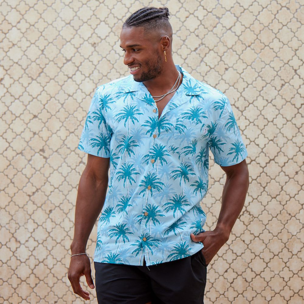 This shirt is a must-have for anyone looking to add a touch of tropical flare to their wardrobe. Featuring a modern, blue palm tree pattern printed on 100% cotton for a comfortable fit and feel. With its bright colours, unique design, and comfortable fit, you'll be sure to turn heads in this stylish Hawaiian shirt.  Add a touch of island vibes to your wardrobe today! Shop the collection.