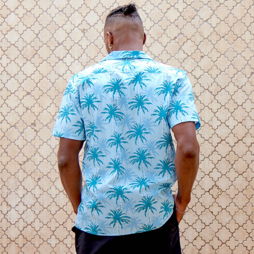 This shirt is a must-have for anyone looking to add a touch of tropical flare to their wardrobe. Featuring a modern, blue palm tree pattern printed on 100% cotton for a comfortable fit and feel. With its bright colours, unique design, and comfortable fit, you'll be sure to turn heads in this stylish Hawaiian shirt.  Add a touch of island vibes to your wardrobe today! Shop the collection.