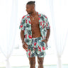 Looking for a stylish and comfortable outfit for your next summer adventure? Check out the Summer Daze Mens Shirt & Shorts set, featuring a modern Aussie twist with white and green stripes and beautiful Waratah flowers. This outfit is perfect for any outdoor activity, from beach parties to backyard BBQs.  Level up the look and add a matching Unisex Shirt or Crop Shirt for your partner. View the Summer Daze Collection. 