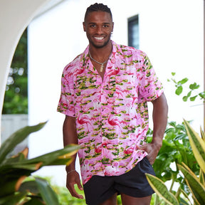 This classic men's Hawaiian shirt features vibrant pink flamingos printed on 100% rayon fabric. Complete with coconut buttons, it's perfect for a stylish yet comfortable island-style look. Steal the spotlight everywhere you go.  Go all out matching with the whole family! Shop the Pink Flamingo Collection. 