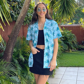 Let yourself feel the island vibes with this unique blue aloha shirt. The classic Hawaiian pattern with palm trees will have you feeling like a beachcomber even in corporate headquarters!  100% cotton ensures a comfortable fit for all day wear, whether you’re heading out on a cruise or to the office. It's truly a shirt "to-tally" worth getting your hands on!