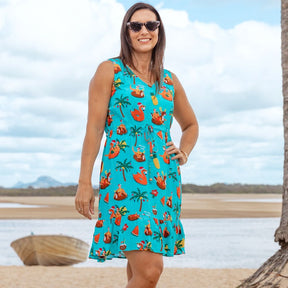 Ready to make a splash this holiday season? Our Christmas Pool Party dress is the perfect way to make a statement that's sure to be remembered. With a festive print and lots of sass, it's the perfect 'lil number for a party on the pool deck! Boom!  This dress features a soft v-neck, adjustable (non-elastic) waist tie, and ruffled hem. 100% Rayon.