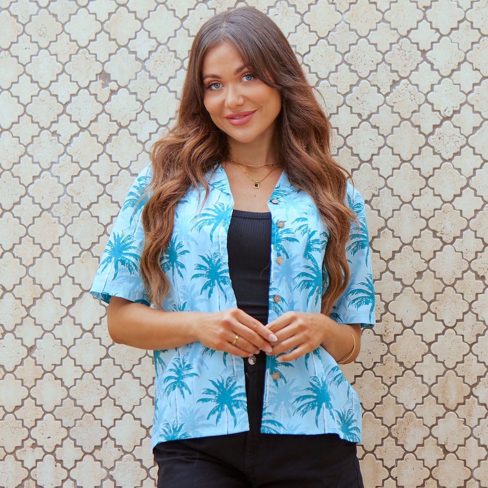 Sport your island look with this Island Blues Women's Hawaiian shirt. Perfect for a cruise or an aloha-inspired uniform, this 100% cotton shirt is that tropical paradise you've been dreaming of! With an eye-popping palm tree print in classic blues, it will have you ready for some sweet island vibes. Aloha!