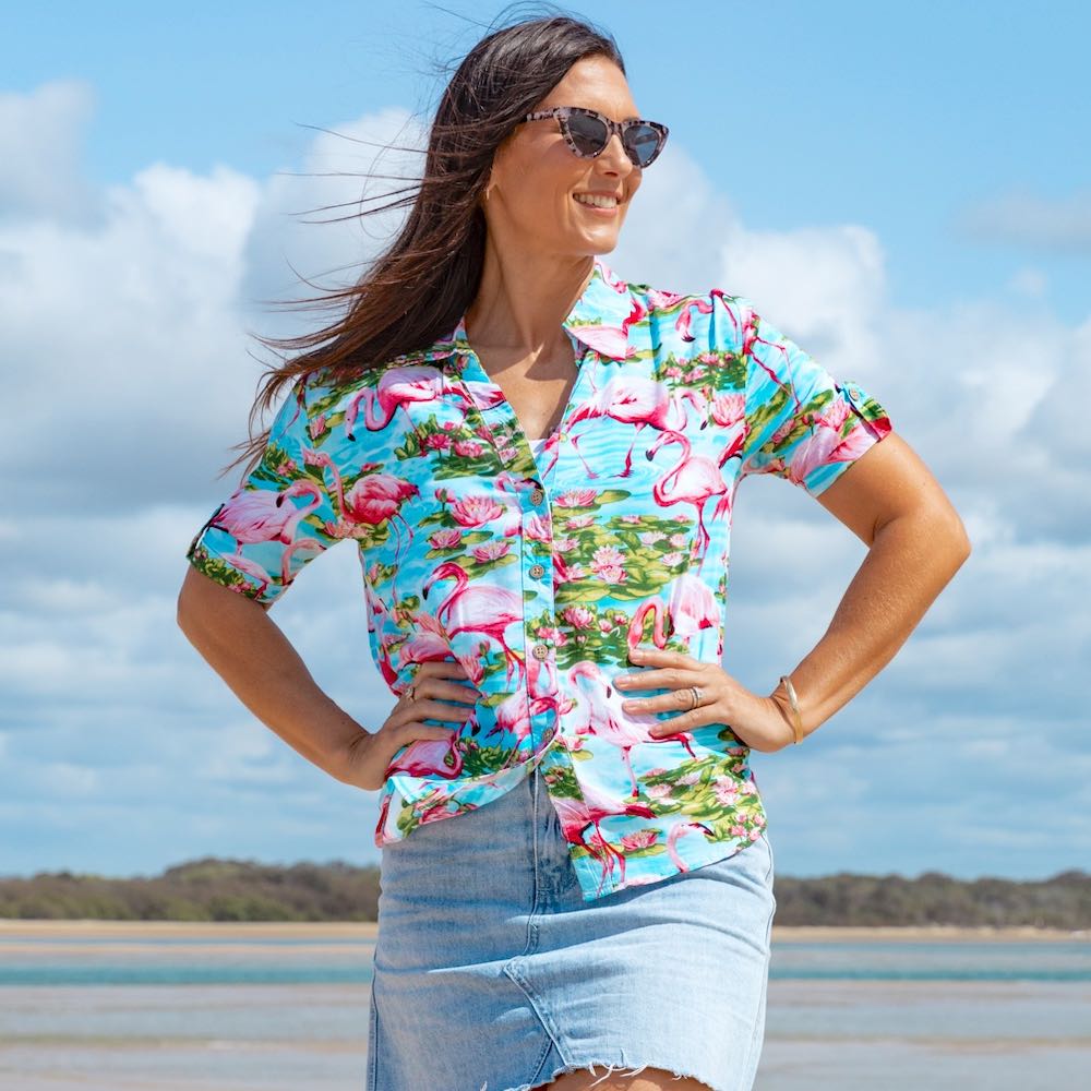 Don't blend in—stand out in this chic and out-there Turquoise Flamingo Hawaiian shirt! The beautiful blue base with pink flamingos is sure to make a statement, perfect for cruises, beach days, or just looking fly. Made of 100% soft rayon, it's lightweight and comfortable but still as fashionable as you please. Rock it and own it, girl!  Please note: Some of the collars and sleeves vary for the sizes.  Be that cute matching couple - add the matching Shirt for him or kids shirt. 