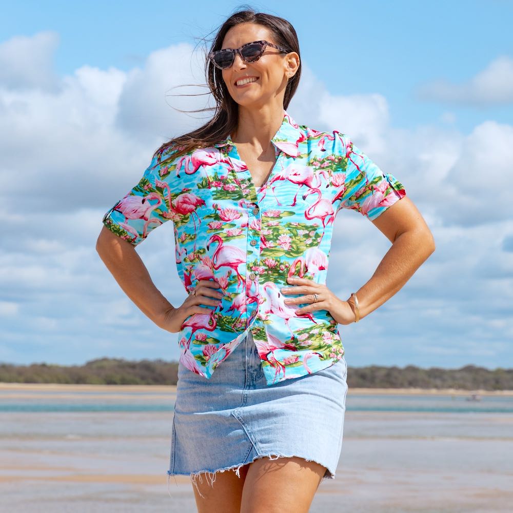 Don't blend in—stand out in this chic and out-there Turquoise Flamingo Hawaiian shirt! The beautiful blue base with pink flamingos is sure to make a statement, perfect for cruises, beach days, or just looking fly. Made of 100% soft rayon, it's lightweight and comfortable but still as fashionable as you please. Rock it and own it, girl!  Please note: Some of the collars and sleeves vary for the sizes.  Be that cute matching couple - add the matching Shirt for him or kids shirt. 
