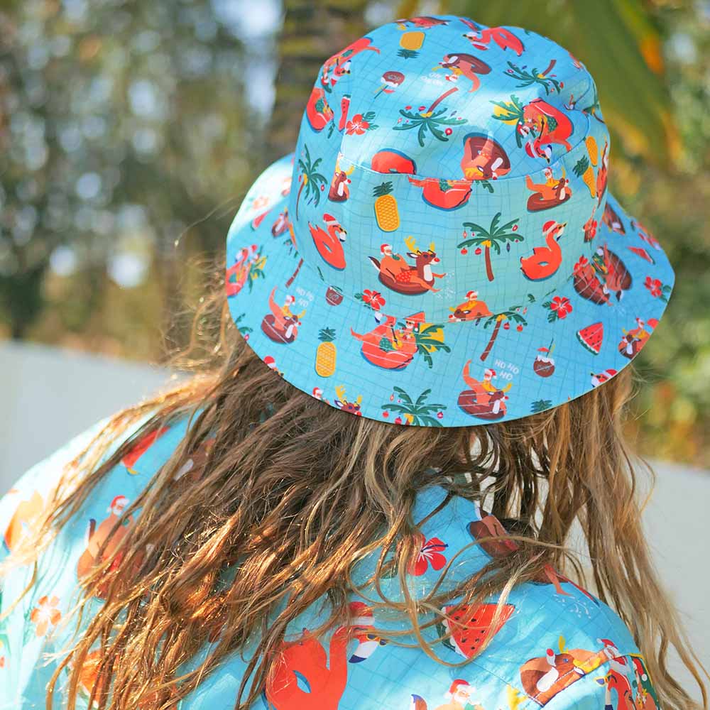 Christmas Pool Party Bucket Hat Unisex Mens or Womens Adult Australia PartyStand out from the crowd in this Christmas print Bucket Hat! It's made for the Aussie summer and get for keeping off the sun on Christmas Day. It also perfectly pairs with the matching Xmas shirts and swim shorts. View the Christmas Collection. 