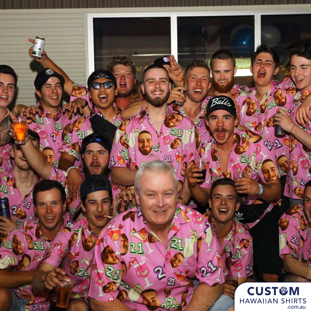 a group of men in pink custom hawaiian shirts posing for a picture